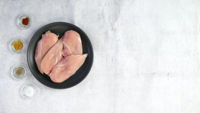 raw poultry in black dish on grey table